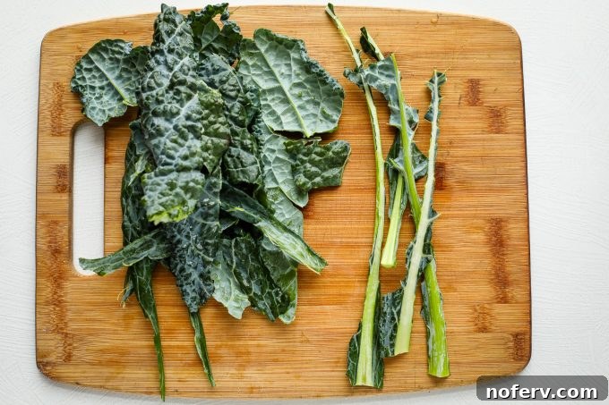 4 Reasons Why You've Misjudged Kale 3 Finely chopped kale on a wooden cutting board, ready for preparation.