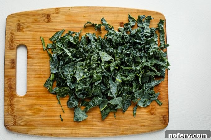 4 Reasons Why You've Misjudged Kale 4 Close-up of fresh Lacinato kale leaves, showcasing their texture before preparation.