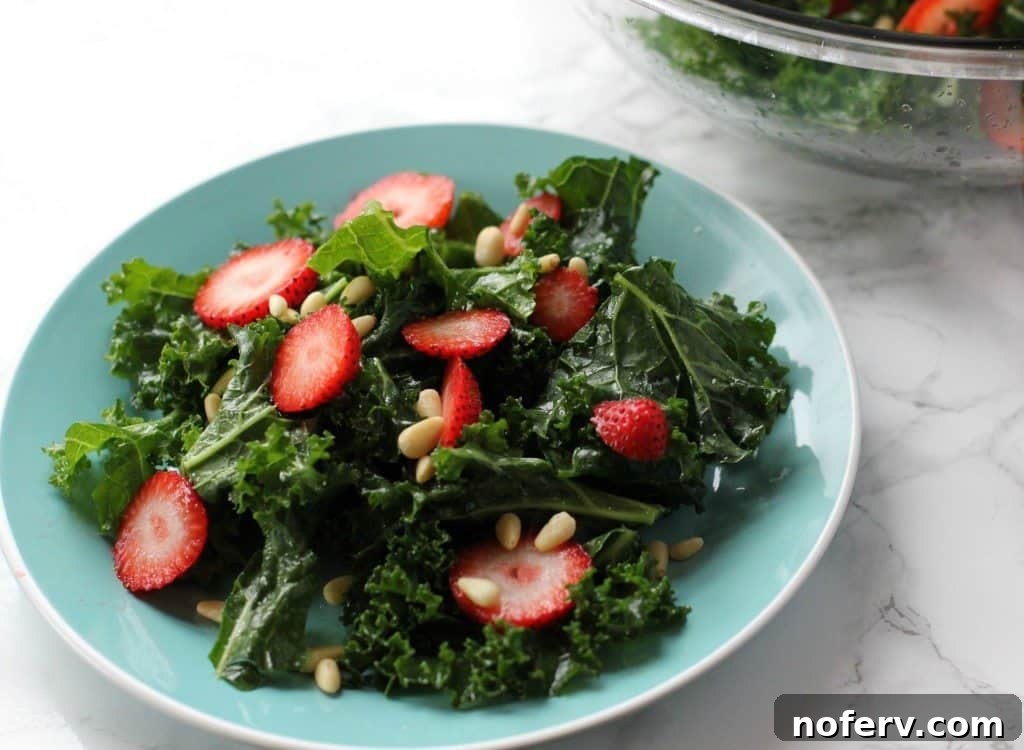 4 Reasons Why You've Misjudged Kale 5 Fresh kale salad with a light white balsamic vinegar dressing in a glass bowl, garnished with herbs.