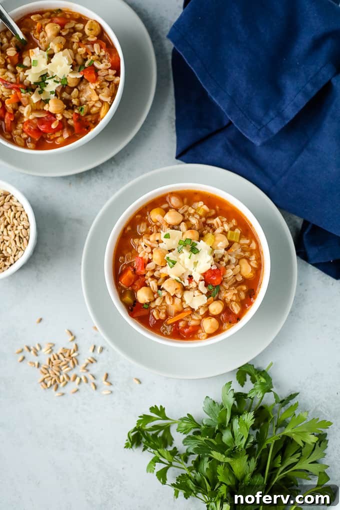 Hearty Chickpea Farro Soup served in a bowl, garnished with fresh herbs.