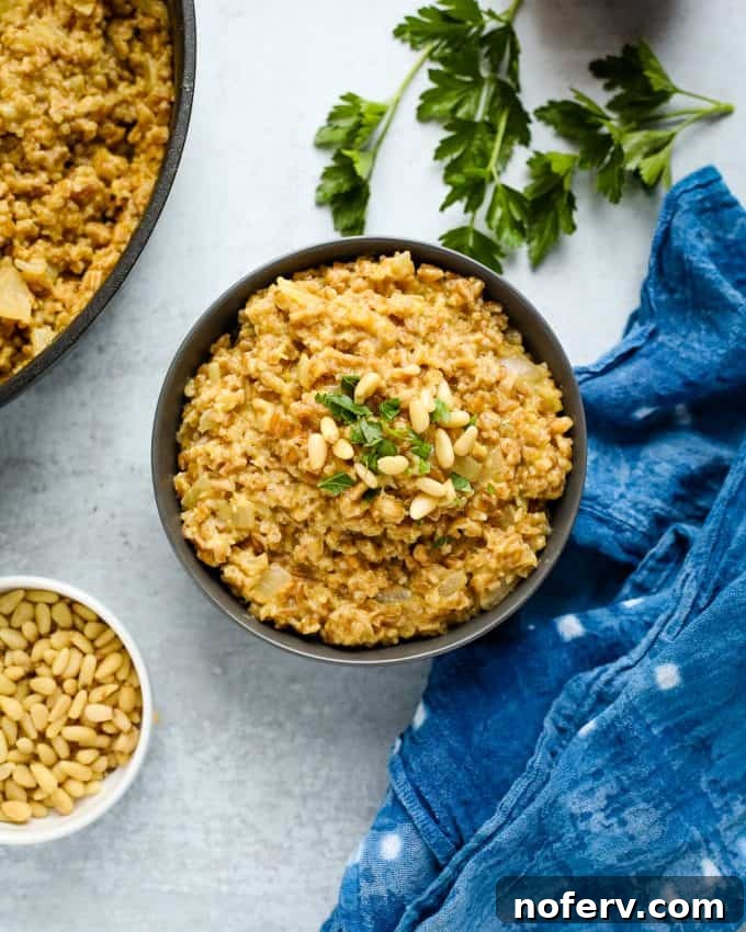 Creamy farro risotto with mushrooms, ready to be served from a pot.