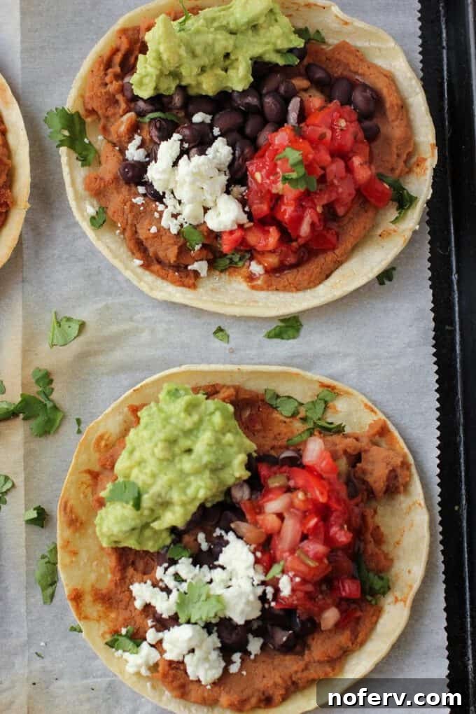 Crispy tostada shells baking on a sheet pan, showcasing the oven-baked method for quick preparation.