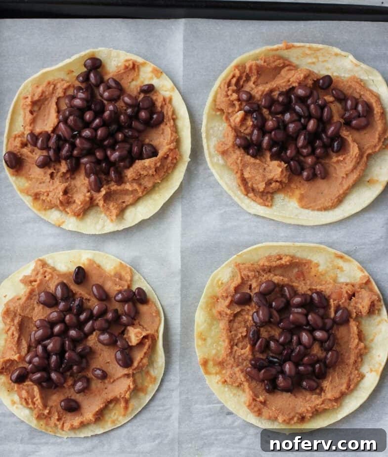 Three tostadas baking in the oven, showing the golden-brown tortillas and heated bean toppings.