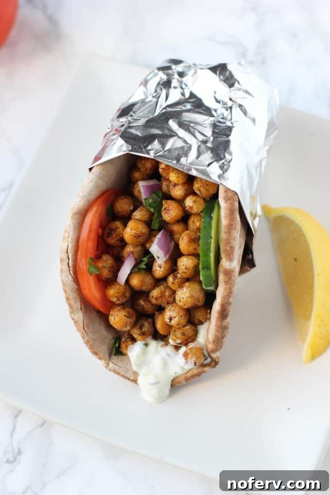 Close-up of a chickpea gyro, highlighting the texture of the chickpeas and fresh toppings.