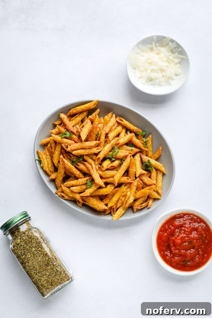 Crispy air fryer pasta chips on a plate, garnished and ready for dipping.