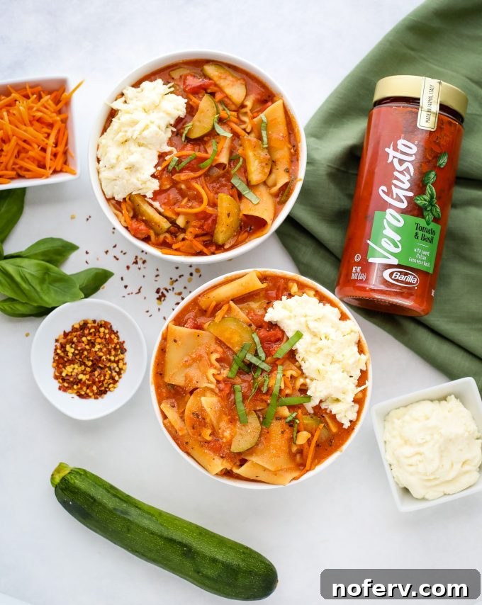 A steaming bowl of vegetarian lasagna soup, garnished with fresh basil and melted cheese, perfect for a cozy meal.