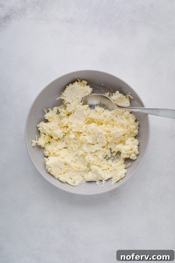 A bowl of creamy ricotta cheese, ready to be mixed with other cheeses for the lasagna soup topping.