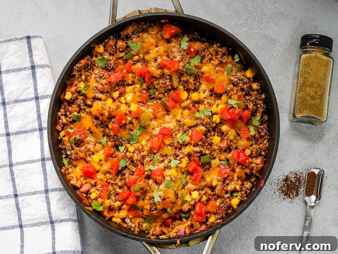 A hearty quinoa taco skillet, featuring fluffy quinoa, beans, and melted cheese, perfect for a quick weeknight meal.