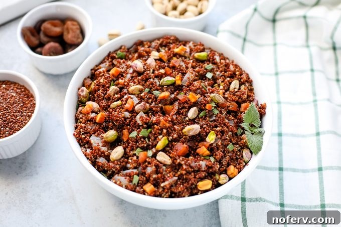 Easy Quinoa Pilaf made with sweet dried apricots and salty pistachios, serving as a flavorful side dish or salad base.
