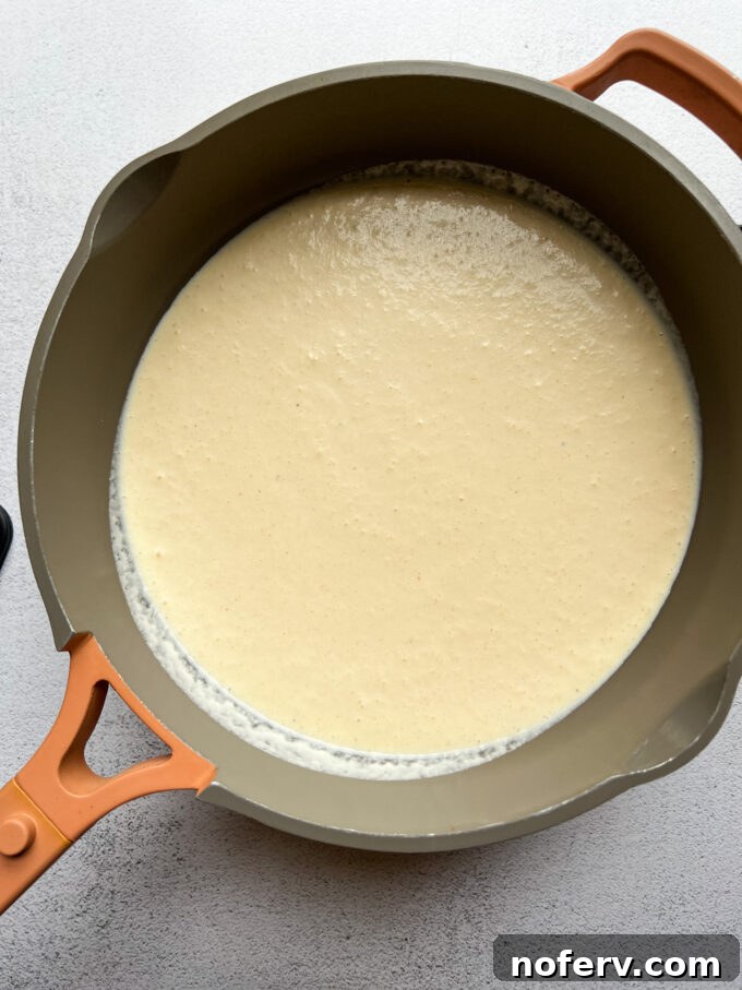 Silky Cottage Mac & Cheese 5 Cheese sauce thickening in a skillet