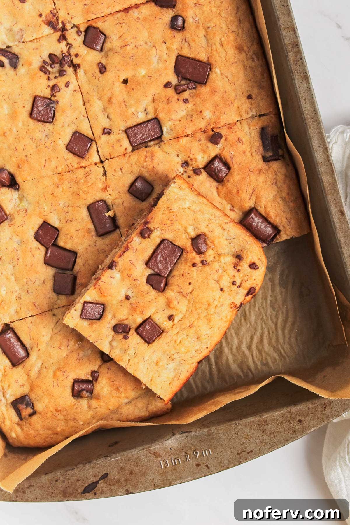 Delicious and fluffy vegan sheet pan pancakes topped with fresh fruit and syrup