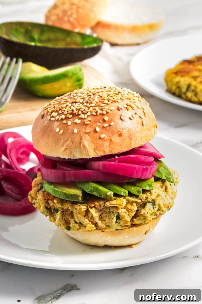 Golden Chickpea Burger Delights 2 Hearty homemade chickpea burgers on a bun with fresh toppings.