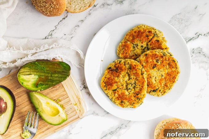Golden Chickpea Burger Delights 3 Close-up of chickpea burger patties on a baking sheet before cooking.