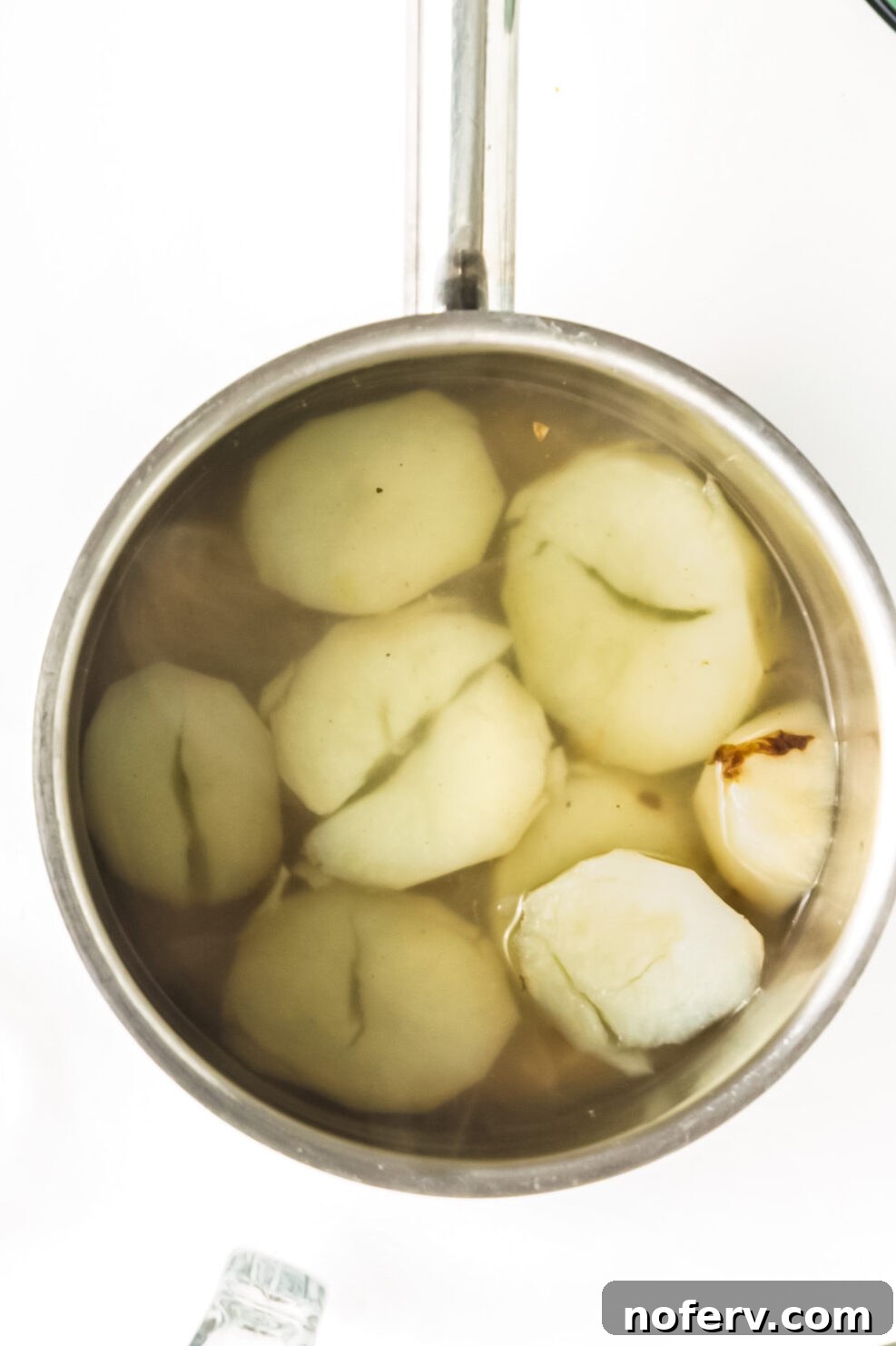 Golden Chickpea Burger Delights 4 Small pot of boiling water with diced potatoes.