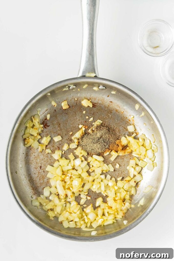 Golden Chickpea Burger Delights 5 Sautéing diced onions in a pan with olive oil.