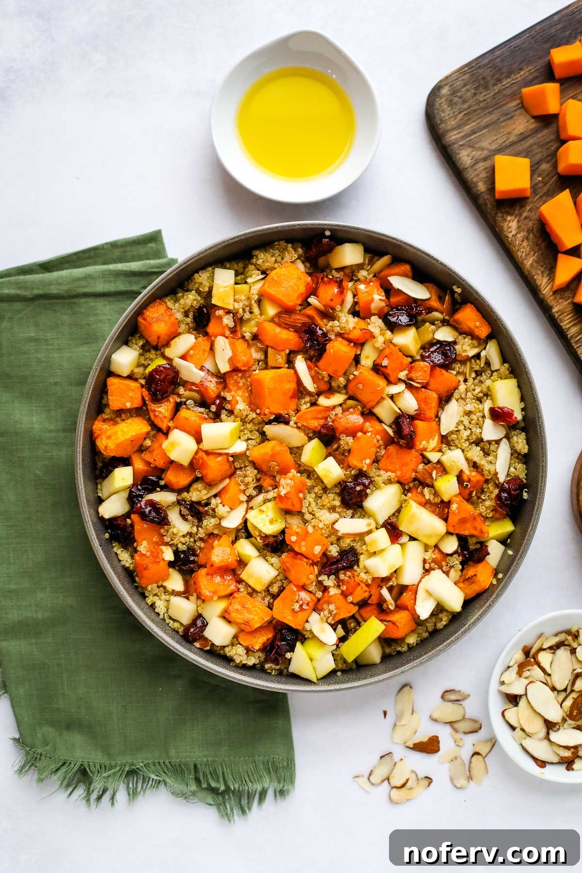 Roasted Butternut Squash and Quinoa Power Bowl 2 Vibrant Butternut Squash and Quinoa Salad in a serving bowl, garnished with fresh herbs