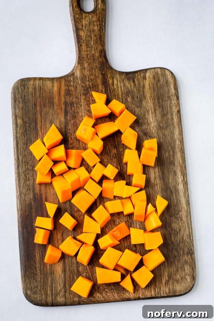 Roasted Butternut Squash and Quinoa Power Bowl 4 Neatly chopped butternut squash cubes on a cutting board, ready for roasting