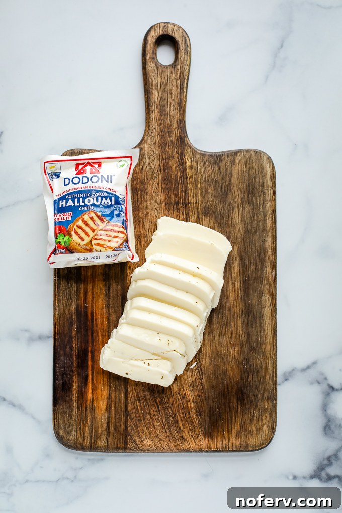 Squeaky Surprises: Inventive Halloumi Creations 2 Fresh halloumi cheese block on a wooden cutting board, ready for preparation.
