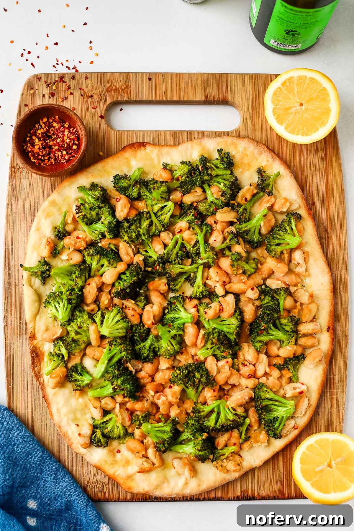 Vibrant Vegan Broccoli Pizza 2 Delicious Vegan Broccoli Pizza with creamy white beans and garlic on a wooden board