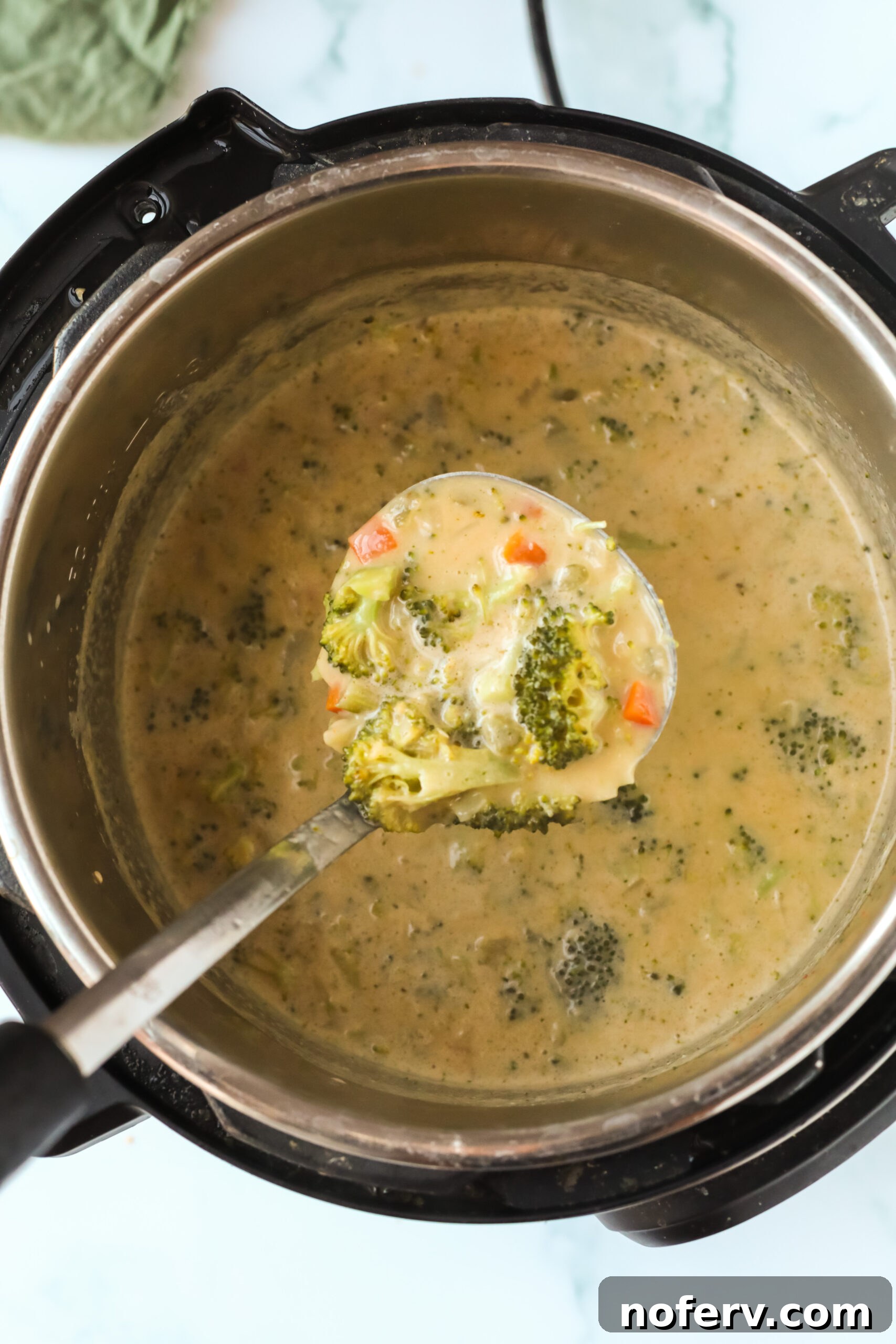 Creamy Instant Pot Broccoli Cheddar Soup, garnished with fresh parsley.