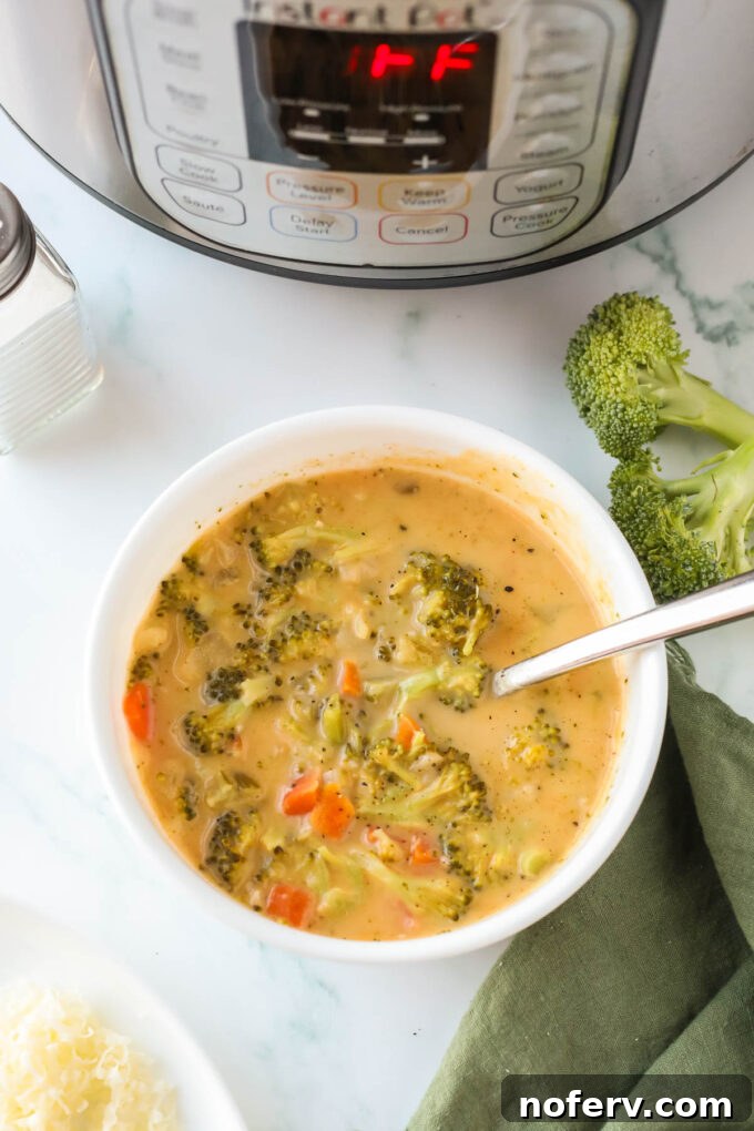Finished broccoli cheddar soup in serving bowls, garnished.