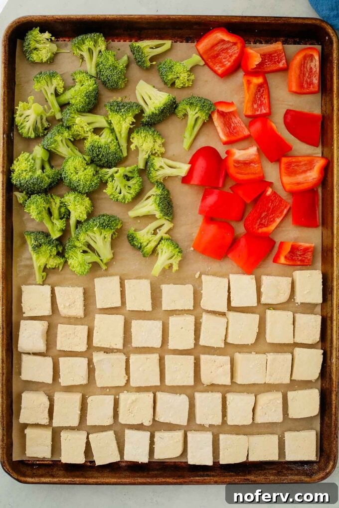 Effortless Sheet Pan Teriyaki Tofu 4 Tofu, broccoli, and bell pepper spread on a baking sheet