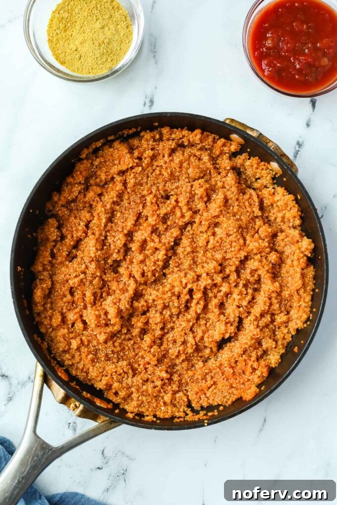 Savory Quinoa Taco Filling 4 Adding garlic to the quinoa mixture in a skillet.
