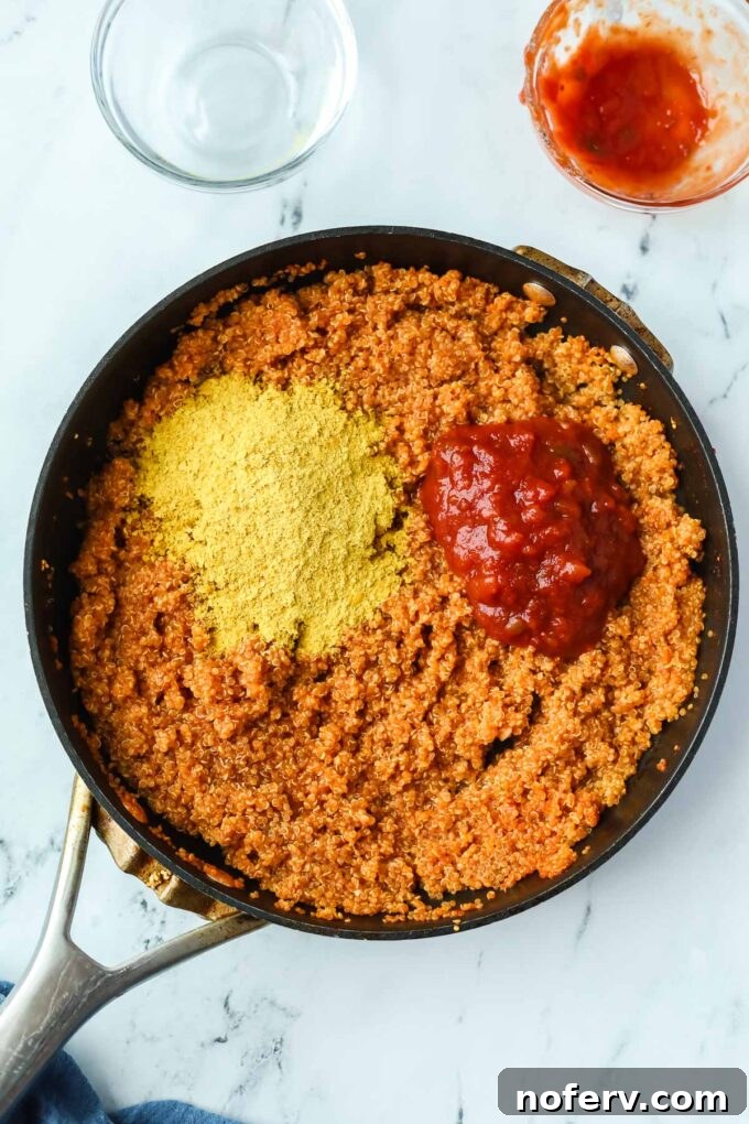 Savory Quinoa Taco Filling 5 Quinoa simmering in vegetable broth in a skillet.