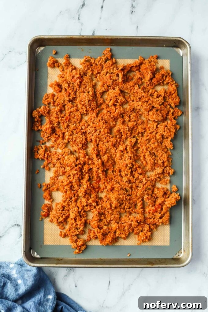 Savory Quinoa Taco Filling 7 Spreading quinoa mixture onto a baking sheet for crisping.