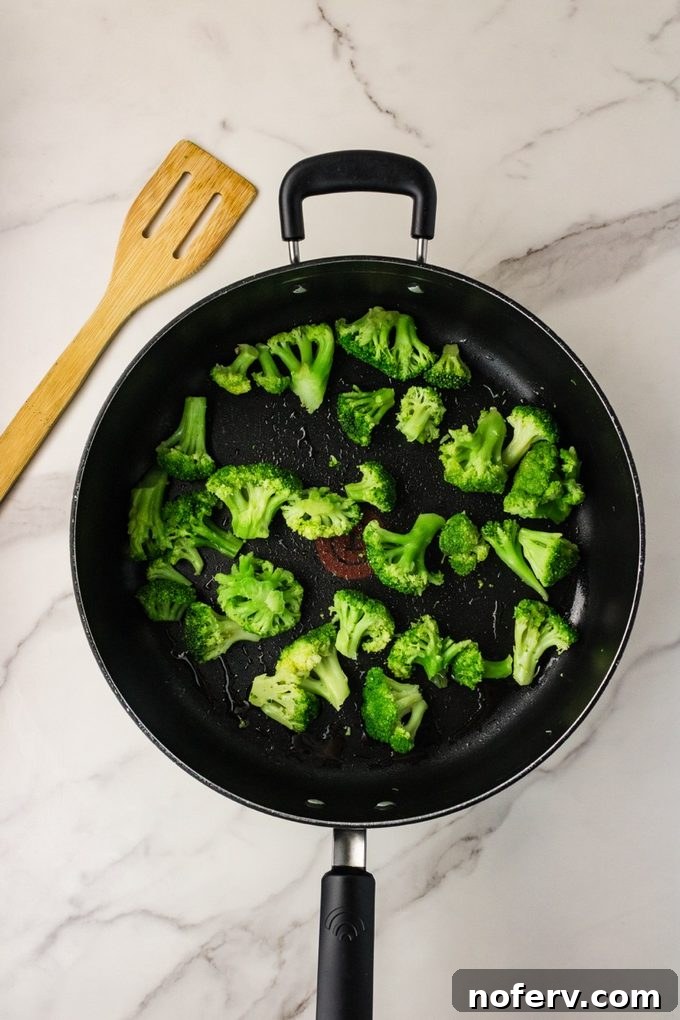 Sweet-Savory Teriyaki Rice Noodles with Veggies 5 Broccoli cooking in a skillet