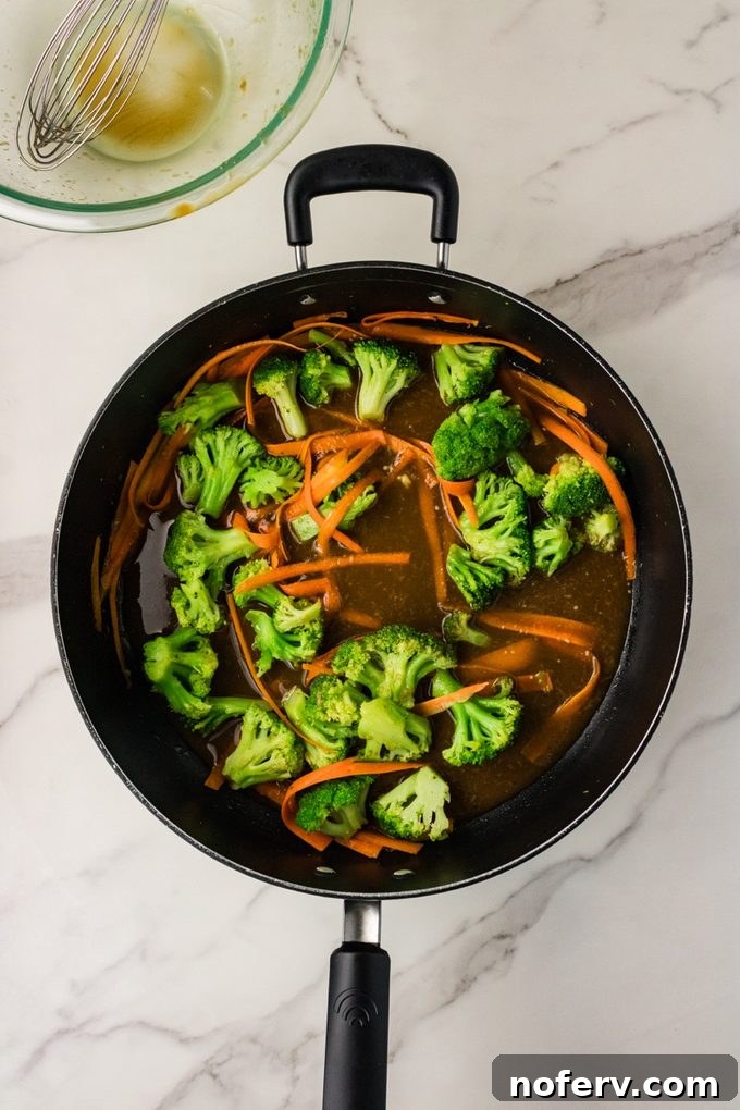 Sweet-Savory Teriyaki Rice Noodles with Veggies 7 Pouring teriyaki sauce into pan