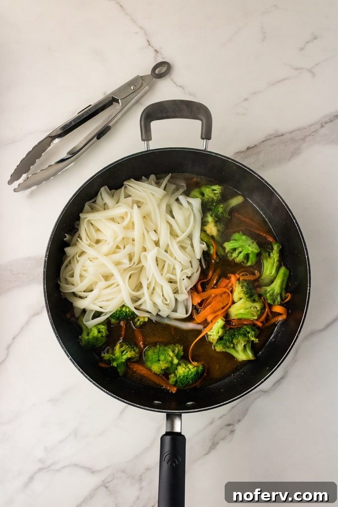 Sweet-Savory Teriyaki Rice Noodles with Veggies 8 Tossing noodles in skillet